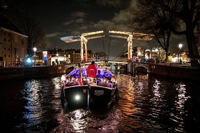 Amsterdam Canal Cruise With Live Guide and Unlimited Drinks - Amstel to the Opera: classy canals and city contrasts