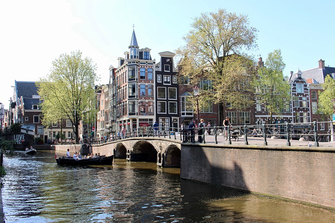 Amsterdam Canal Tour by Open Boat – 90 min Small Group Experience - Amstel River start: dancing houses, leaning buildings, and Munt Tower