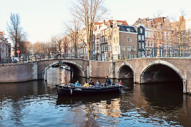 Amsterdam Canal Tour by Open Boat – 90 min Small Group Experience - Kolksluis and old warehouses: Middle Ages lock vibes and the canals’ working past