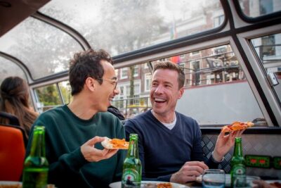Amsterdam Guided Cruise with New York Pizza, Drinks and Ice Cream - The canal route at night: how each landmark changes the vibe