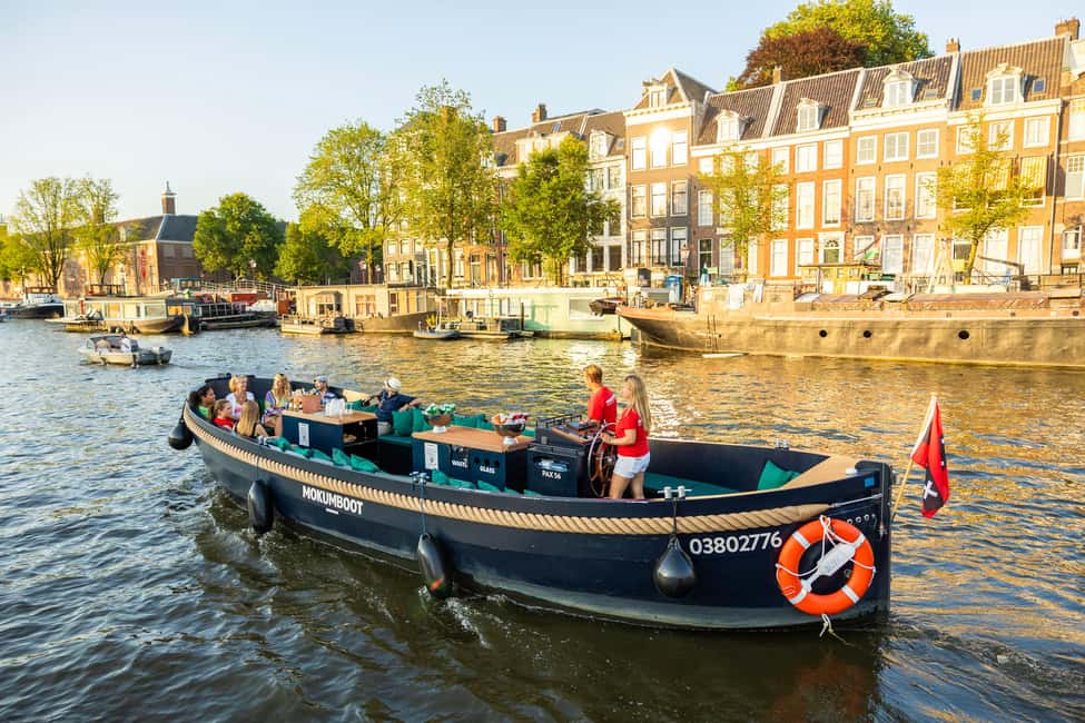Amsterdam: Guided Open Boat Canal Cruise Including Drink - Weather-proof comfort: ponchos, blankets, and open-air reality