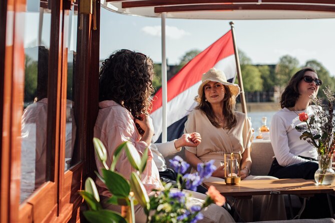 Amsterdam: Luxury Saloon Boat Cruise with Cocktails & Waffle - Drinks, blankets, and comfort on an open-boat setup