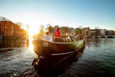 Amsterdam Open Boat Cruise with Live Guide and Two Drinks - The boat: open-air in good weather, heated seating when it’s cold