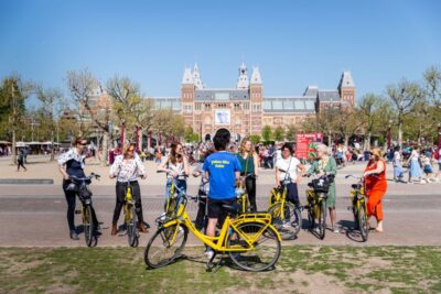 Amsterdam: Relaxed City Highlights Guided Bike Tour - Grachtengordel Canals: The Smallest-House Game and the City Prison Story