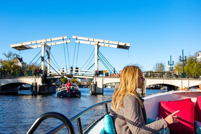 Guided Amsterdam Canal Cruise – Snacks & Drinks on board(1 Hour) - Stop 1 to 3: Red Light District edges, a silent 1306 church, and Dutch East India roots