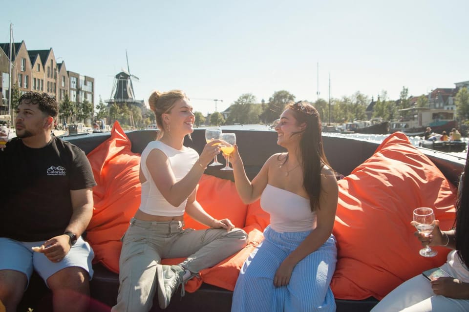Haarlem: Sightseeing Boat Tour with Snacks and Drinks - The boat setup: covered comfort, cushioned seats, and background music